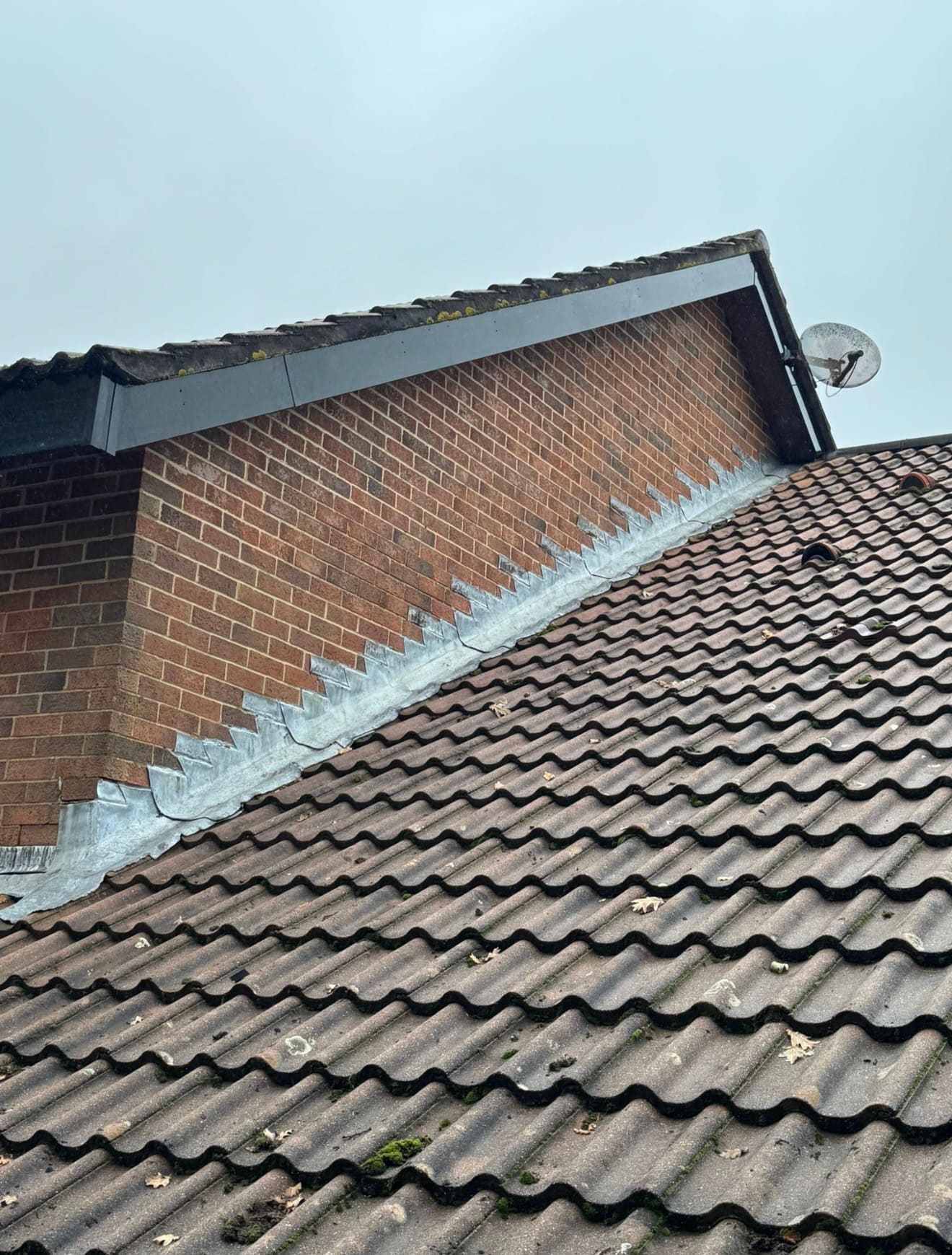 New dark fascia and verge trim along a tiled gable roof